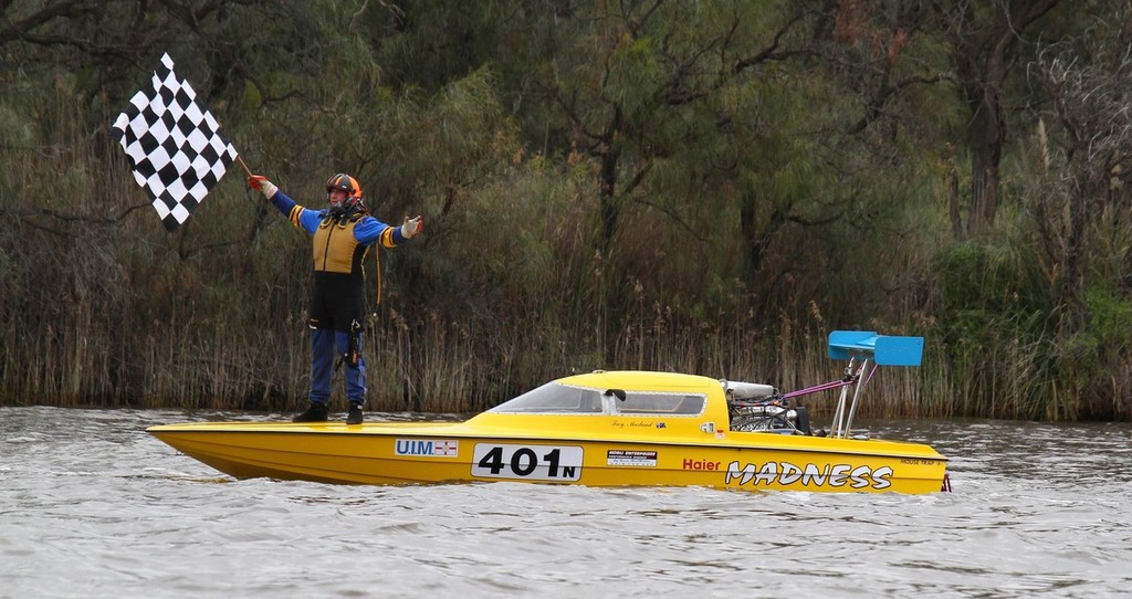 Troy Marland, reigning UIM Unlimited World champion, waves the chequered flag in triumph after winning the coveted crown at Gol Gol, near Mildura, last year.  © Wayne Johnstone